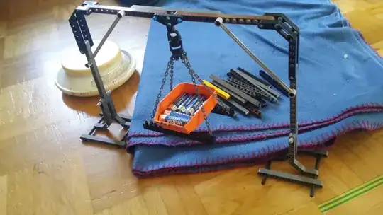 image of an upside-down U frame, with a magnet hanging from the middle of the top beam and a LEGO bucket with six AA batteries hanging via 4 chains from another magnet