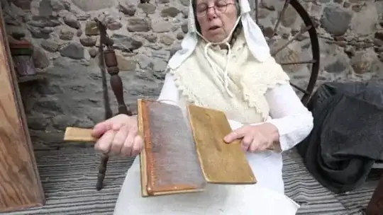 old lady hand carding wool