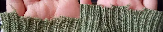 Detail of sleeve fraying damage on 100% wool cardigan 
