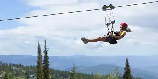 woman riding a zip line