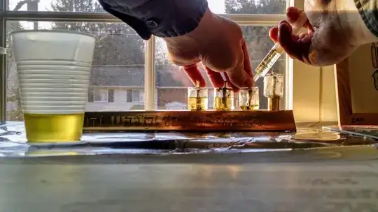 Squirting oil onto a wick using a medicine dropper