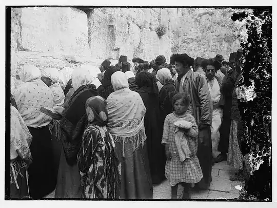 groups of men and women praying at the Wall