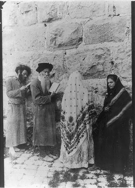 2 men and 2 women standing together with prayerbooks
