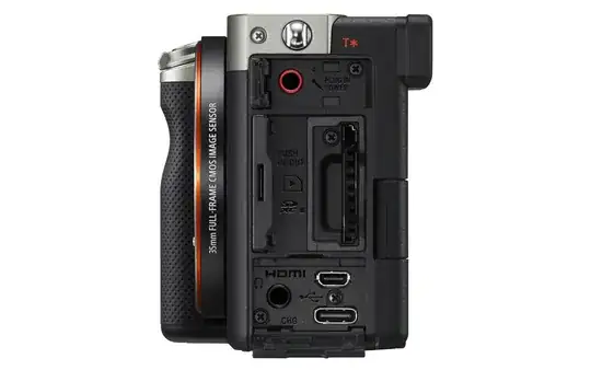 Sony A7C promo image of left side of camera showing the letters "T*" in orange next close to the viewfinder
