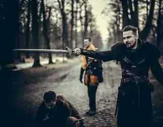 guy pointing sword