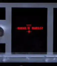 Screenshot of X-Wing cockpit display showing a black screen with blurry red writing on it set in a silver console