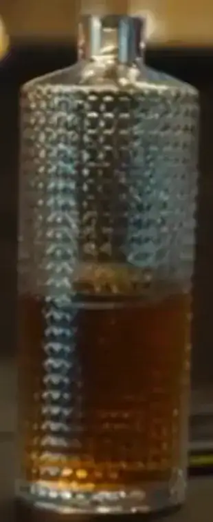 A close up of the studded decanter with whiskey in it