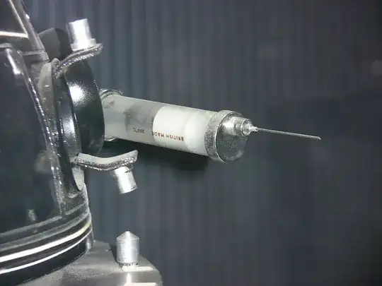 A close up of the syringe on the side of the ITO interrogator droid; it is clear filled with something white and the needle comes out of the top not the centre