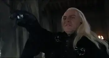 Lucius Malfoy with an expression of hatred, raising his wand to cast a spell