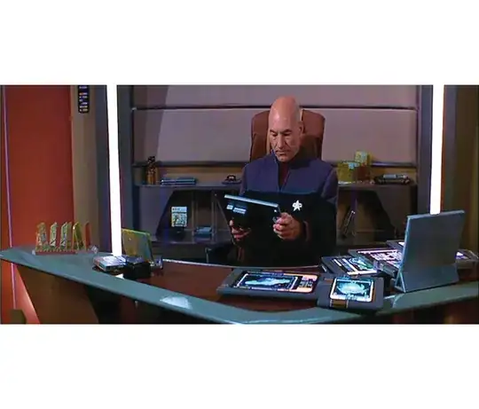 Picard in the Enterprise-E ready room with 5 or 6 PADDs laying on his desk. Two isolinear chip holders are to his left, another is on sitting on a shelf behind to the right of him.