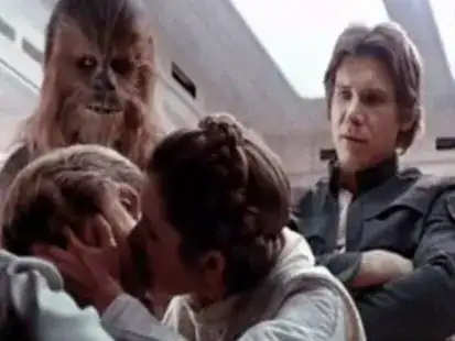 A still from _The Empire Strikes Back_, showing Leia kissing Luke