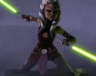 Ahsoka Tano wearing a brown sleeveless tunic, brown arm guards and grey leggings