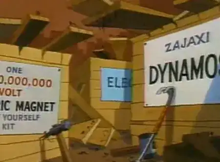 A wooden box with a crowbar leaning against it. It has a white label saying "Zajaxi Dynamo"
