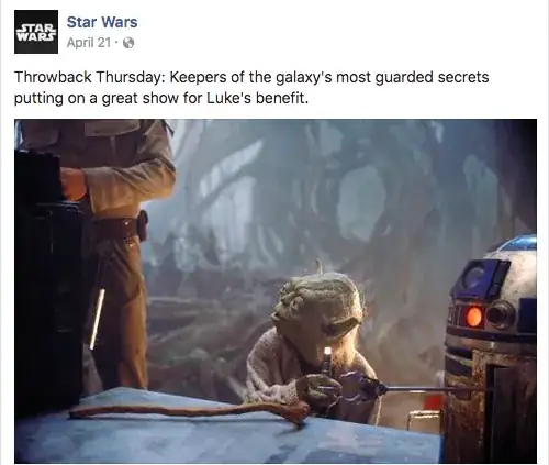 Screenshot from "The Empire Strikes Back" captioned "Throwback Thursday: Keepers of the galaxy's most guarded secrets putting on a great show for Luke's benefit."  The image is centred on Yoda, holding Luke's flashlight in his right hand.  In the foreground is the supply crate which Yoda has put his walking stick on, and to the left we can see part of Luke's torso as he fiddles with another piece of equipment.  A muddy R2-D2 on the right side reaches out a gripper to try to retrieve the light from Yoda, who is looking up and to his right at Luke.
