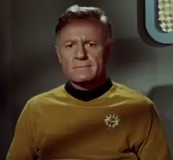 Commodore Barstow, wearing a gold Commodore's uniform