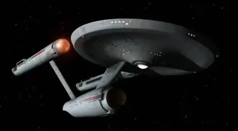 View of TOS Enterprise from below, fore and starboard; Enterprise is illuminated almost directly from starboard, with shadows from the sensor dome and support pylon cast towards the port side.