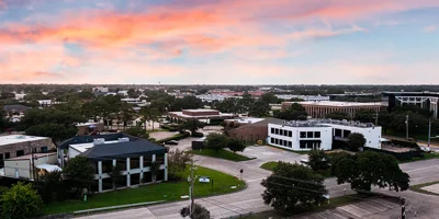 Aerial view of rehab center building surrounded by streets and trees