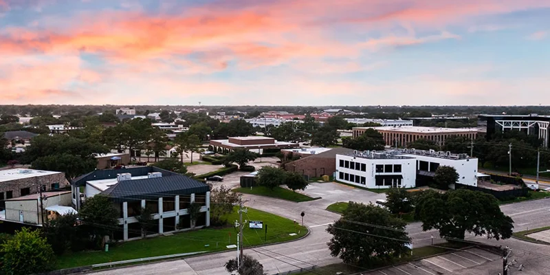 Aerial view of rehab center building surrounded by streets and trees