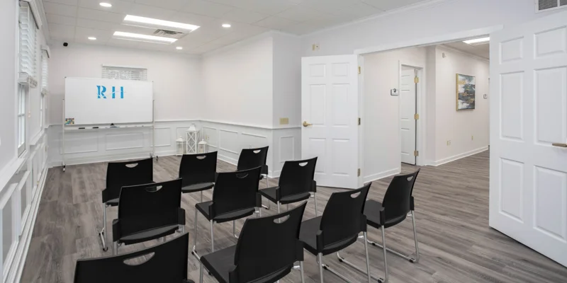 Classroom with chairs arranged in front of a whiteboard.