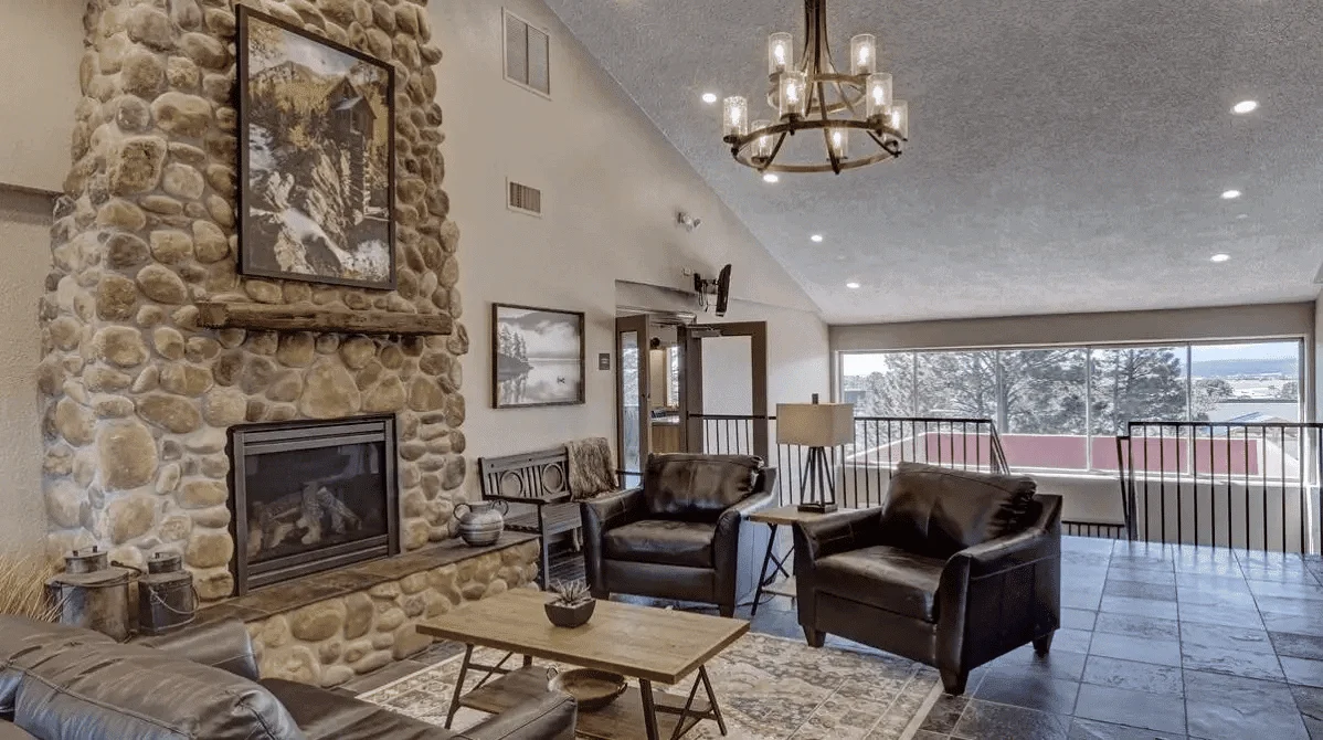 Lounge with  seating, and a fireplace.
