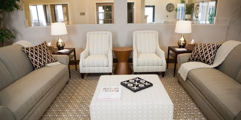 A cozy lounge area with neutral-tone sofas and armchairs