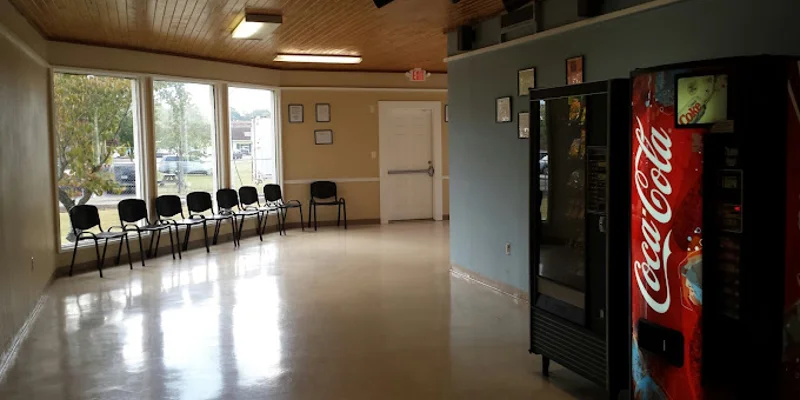Waiting area with chairs and vending machines.