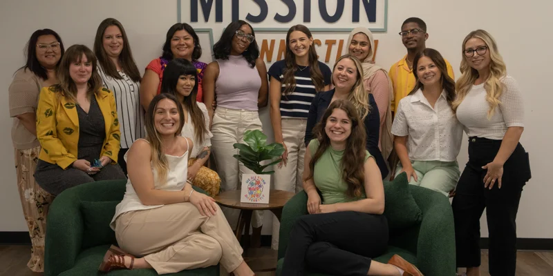 A group of ladies on green couches and Mission Connection.