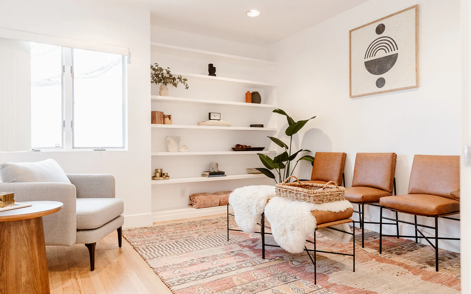 Cozy lounge with warm-toned decor, built-in shelving, and soft lighting.