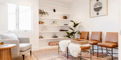 Cozy lounge with warm-toned decor, built-in shelving, and soft lighting.