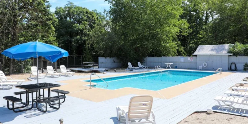 Outdoor pool area with lounge chairs.
