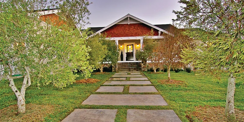 Walkway to facility with trees.