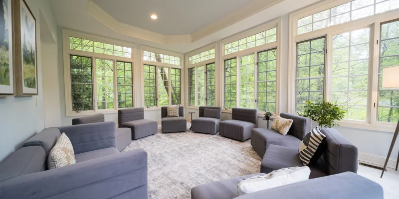 A sunlit therapy room with gray armchairs arranged in a circle