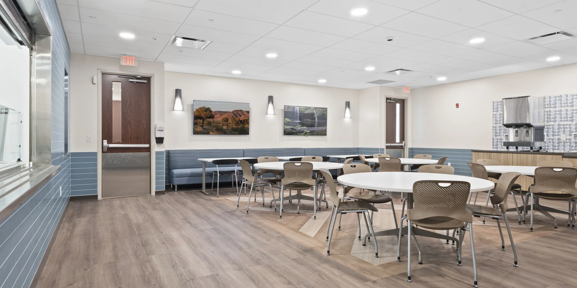 A clean, modern dining area with tables and chairs.