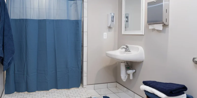 A bright and hygienic bathroom with an easy-access shower.