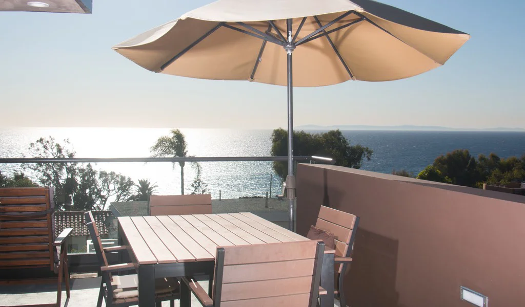 Dining with a large umbrella and seating.