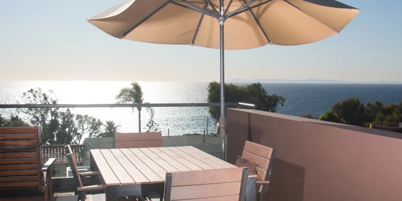 Dining with a large umbrella and seating.