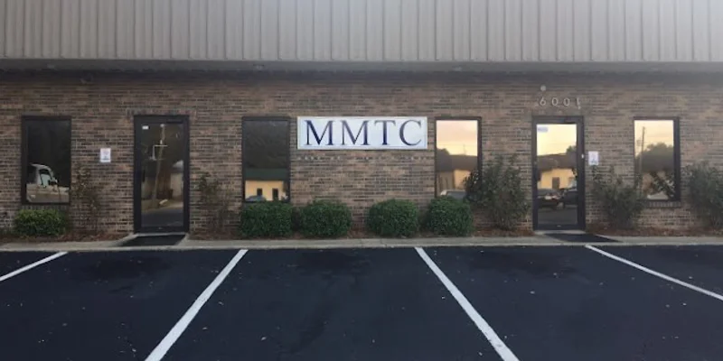 The exterior of a brick rehab facility with a sign reading "MMTC."