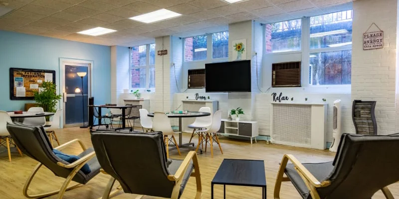 Lounge area with table, chairs and a TV.