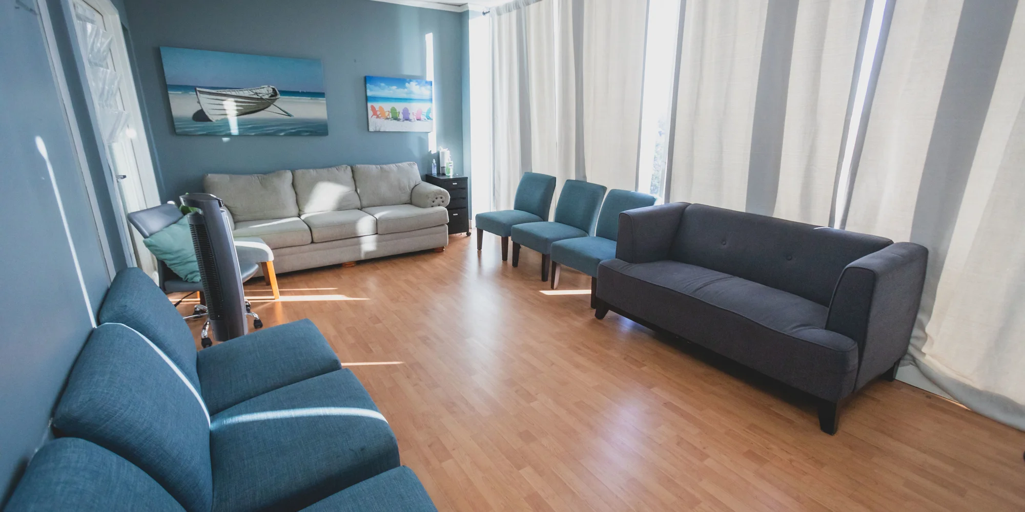 Lounge with seating and large windows.