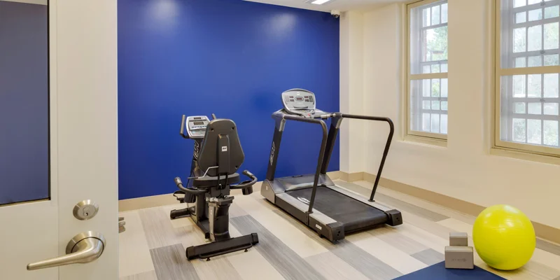 Spacious fitness area with cardio equipment.