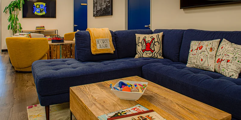 Lounge with a sofa, books, and a TV.