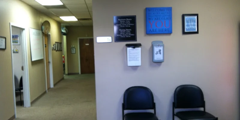 A waiting area with black chairs and informational signs on the wall
