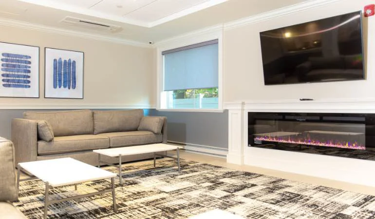Comfortable lounge area with sofas, coffee table, and TV.