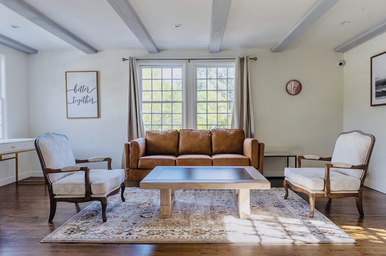 Seating area with a sofa and armchairs.
