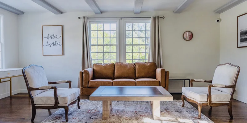 Seating area with a sofa and armchairs.