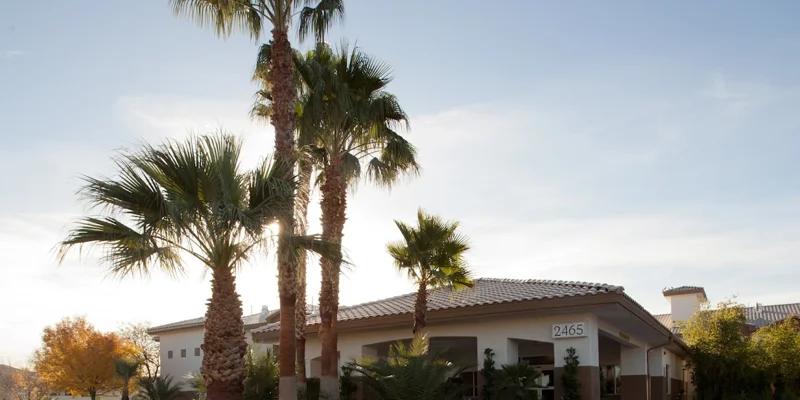 Rehab facility exterior surrounded by palm trees