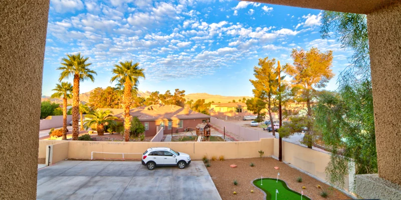 Balcony view with a driveway and a mini golf setup.