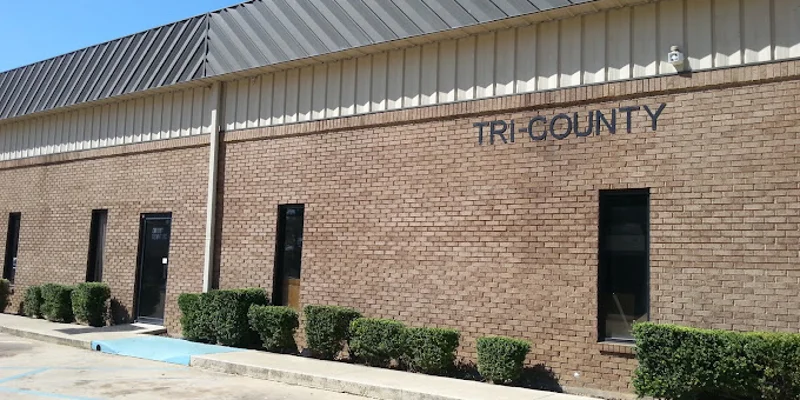 Brick building with "Tri County" signage and accessible parking.
