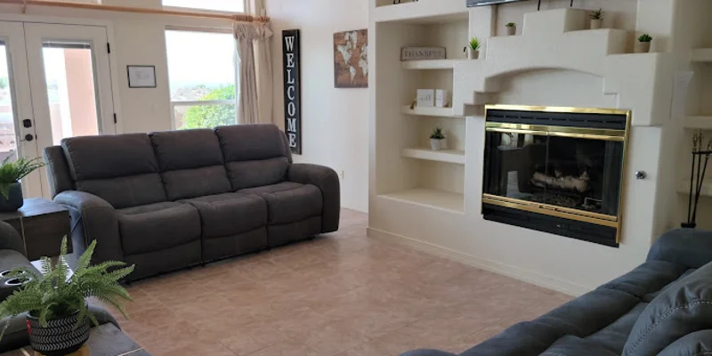Living room with a TV, fireplace and comfortable seating.