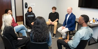 Small group seated in a circle for discussion.